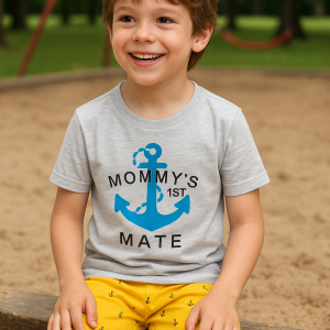 Toddler summer outfit featuring a light purple short-sleeve t-shirt with a blue anchor graphic and "Mommy's 1st Mate" text, paired with bright yellow shorts patterned with small blue anchors.