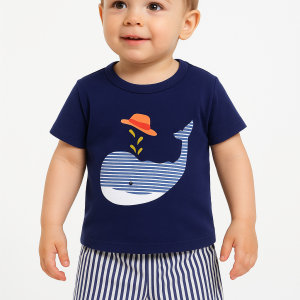 Toddler summer outfit featuring a navy blue- t-shirt with a white- striped whale graphic wearing a red hat and water spout detail, paired with white and navy vertical striped shorts.