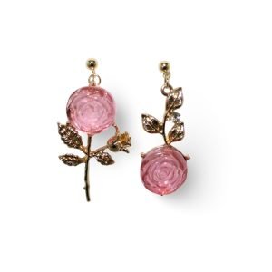 Our earrings feature a delicate rose design crafted from pink resin with intricate gold stems and leaf details.