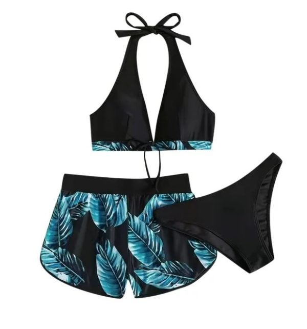 Halter bikini top with a tie neck and tropical leaf print high- waisted shorts, paired with matching bikini bottoms.