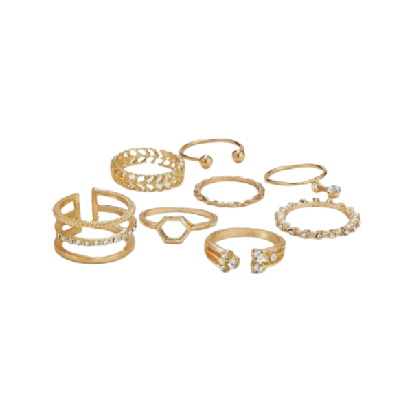 A set of gold rings featuring a variety of designs, including delicate bands, open cuff styles, crystals accents, and intricate geometric and leaf- inspired patterns.
