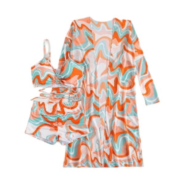 A stylish three- piece swimwear set featuring a bold swirl pattern, including a ruched bikini top, matching shorts, and a coordinating sheer cover- up for a trendy beach or poolside look.